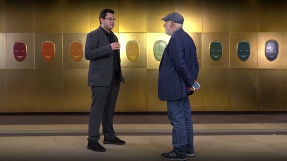Two men stand in front of each other discussing the Universal Acceptance project